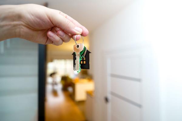 Hand holding house keys